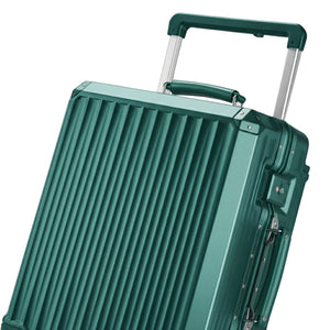 Close-up of a dark green hard-shell suitcase with vertical ridges, aluminum frame, and a telescopic handle.