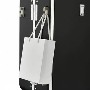 Side hook design on Nordiva Classic black suitcase holding a shopping bag