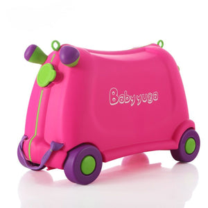 Pink BabyYuga ride-on suitcase with purple and green wheels and handles, shown on a white background.