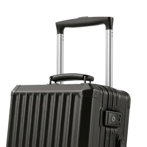 Close-up of a dark grey hard-shell suitcase showing its telescopic handle, top carry handle, and vertical ridge design.