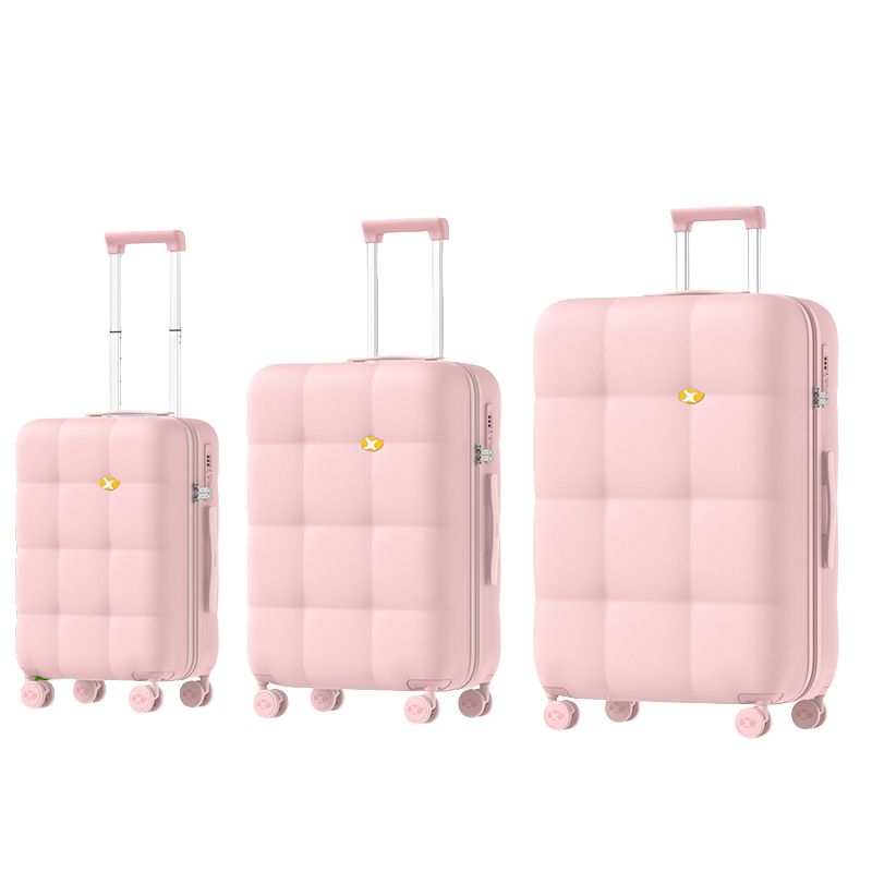 Set of three pink suitcases of different sizes on a white background