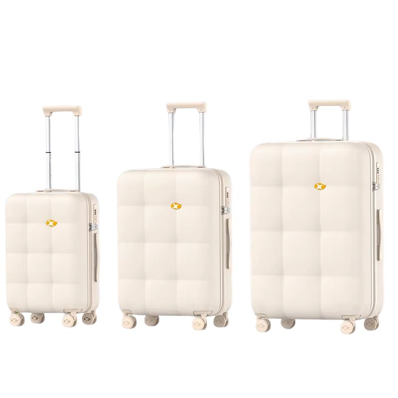 Three cream-colored suitcases of different sizes on a white background