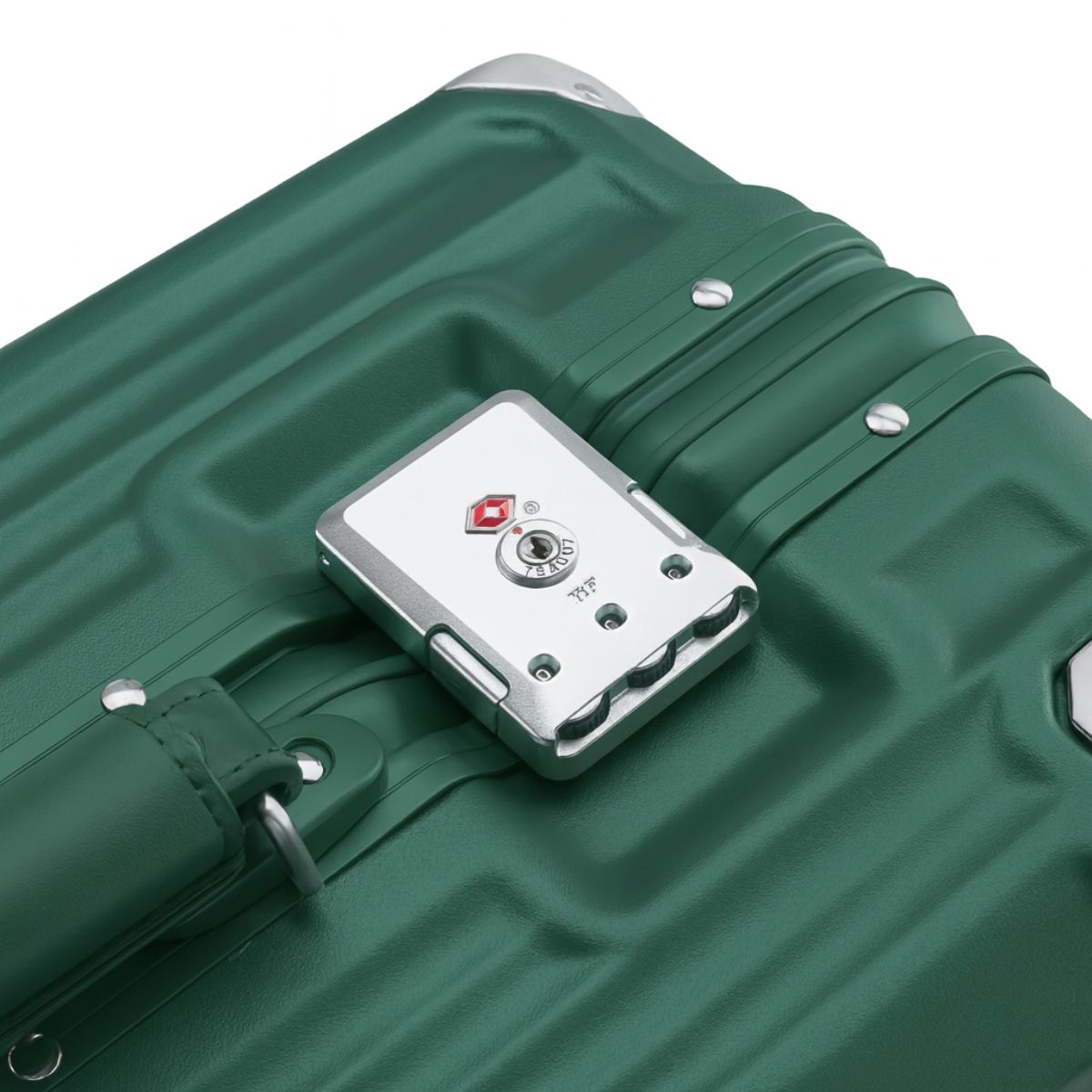 Close-up of a dark green suitcase showing its silver TSA combination lock and textured hard-shell design.