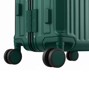 Close-up of a dark green suitcase showing its 360° spinner wheels, reinforced corners, and hard-shell base design.