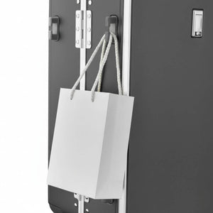 Side hook design on Nordiva Classic dark grey suitcase holding a shopping bag