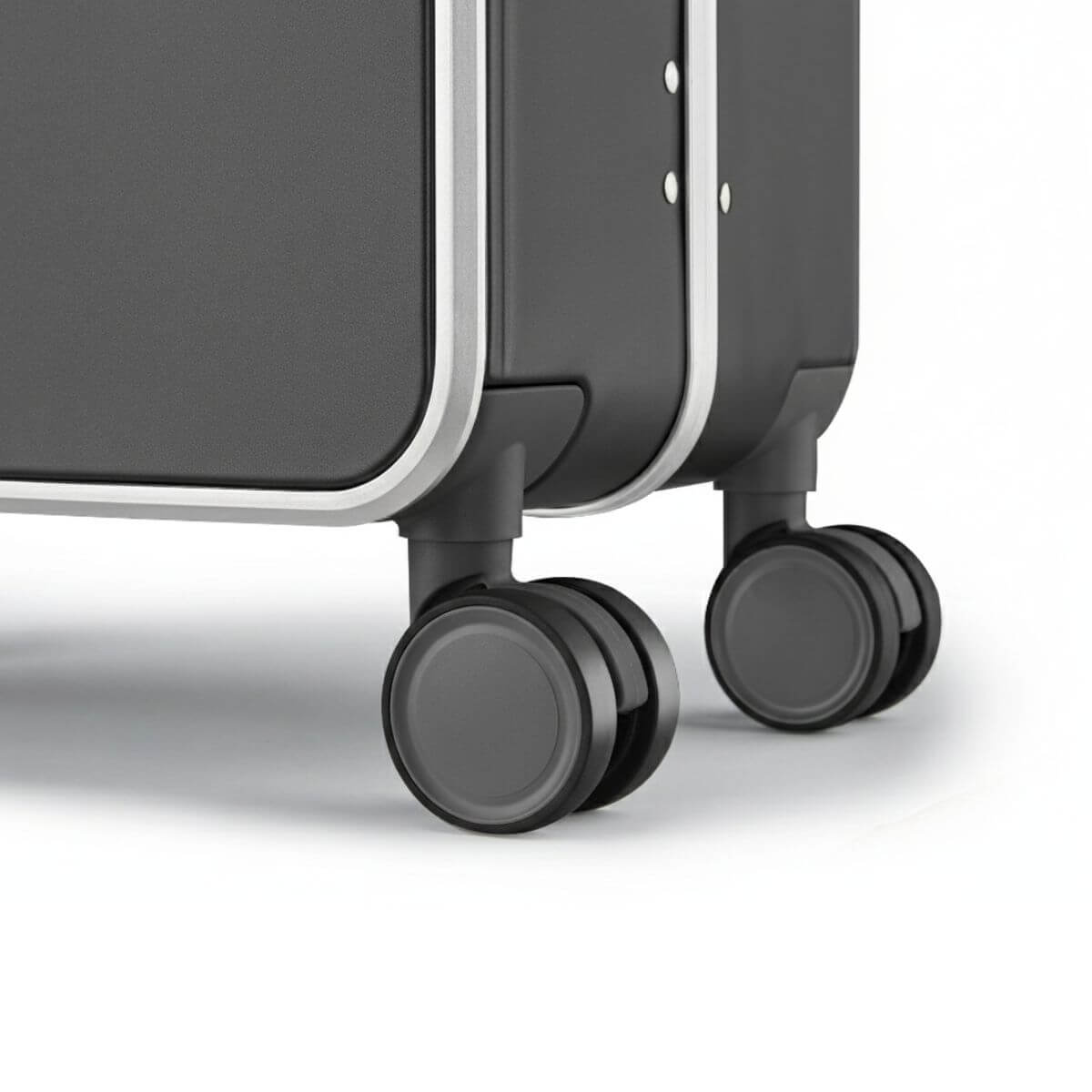 Close-up of dual 360-degree spinner wheels on Nordiva Classic dark grey suitcase