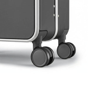 Close-up of dual 360-degree spinner wheels on Nordiva Classic dark grey suitcase