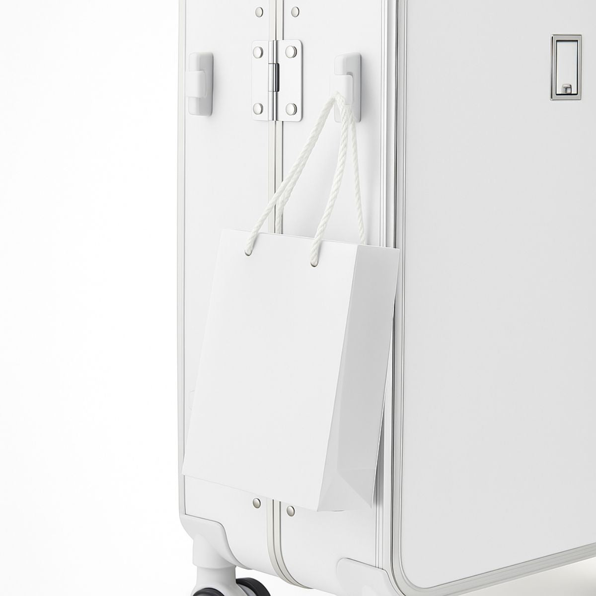White suitcase with a white paper bag attached to it on a white background