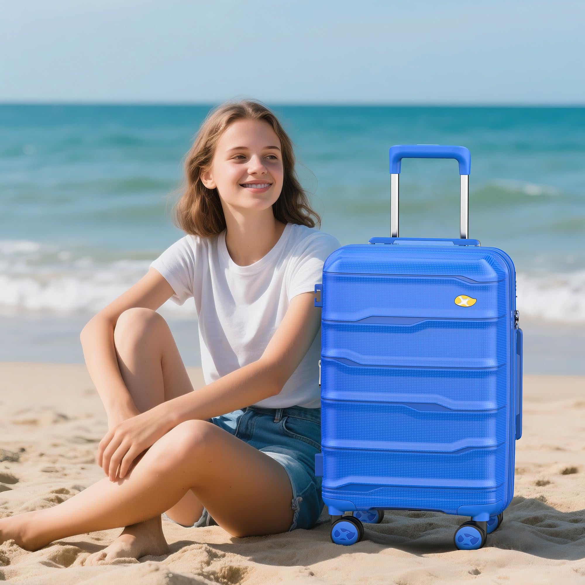 Person sitting on a beach with a blue suitcase