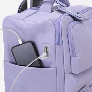 Urbaneo 64cm softside medium check in suitcase — external USB port charging a phone from a power bank